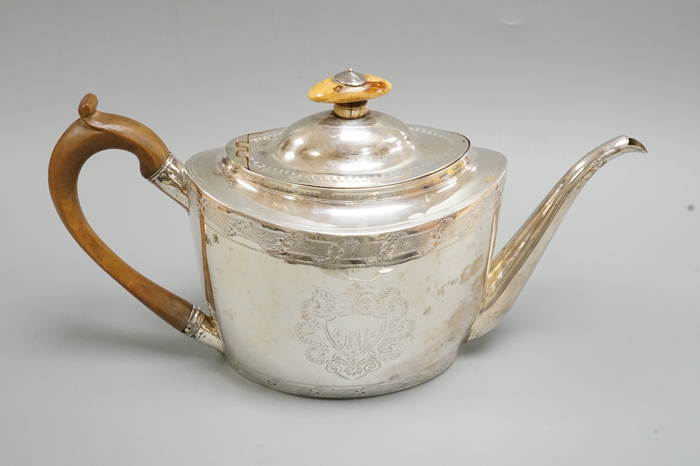 A George III chased oval silver teapot, by Thomas Wallis, London, 1798, gross weight 15.4oz.